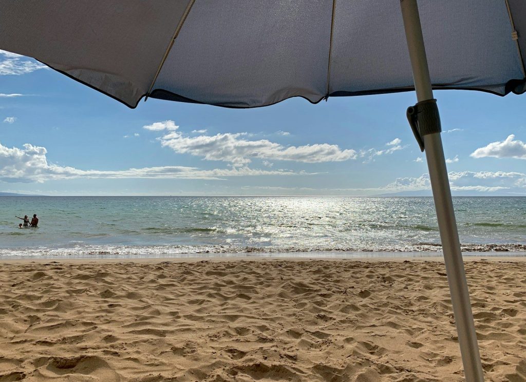 a beach with a couple people